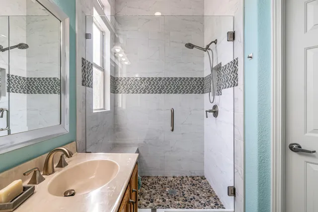 a bathroom with a tub sink and shower