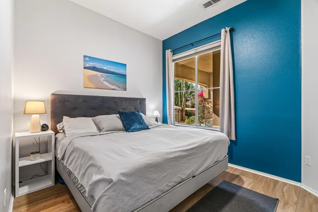 a bedroom with a bed and a window