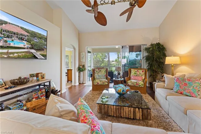 a living room with furniture and a floor to ceiling window