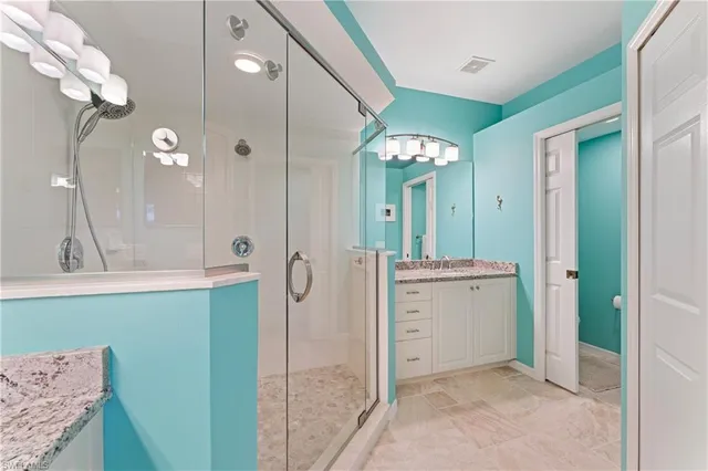 a spacious bathroom with a shower sink and mirror