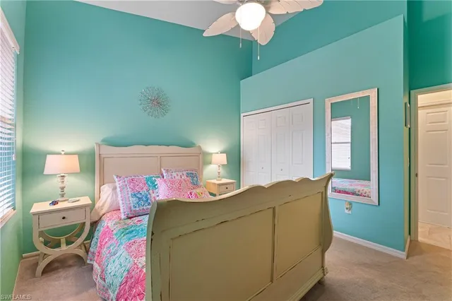 a bedroom with a bed and chandelier