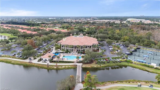 an aerial view of residential houses with outdoor space and river