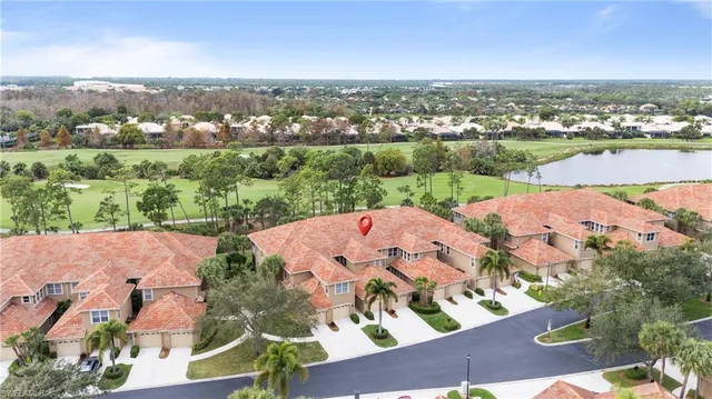 an aerial view of residential houses with outdoor space and river