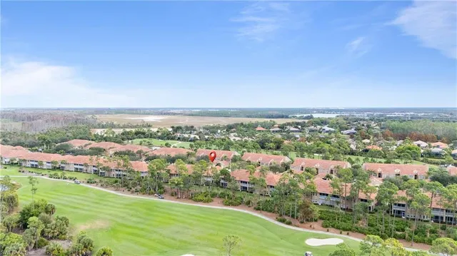 an aerial view of residential houses with outdoor space and trees