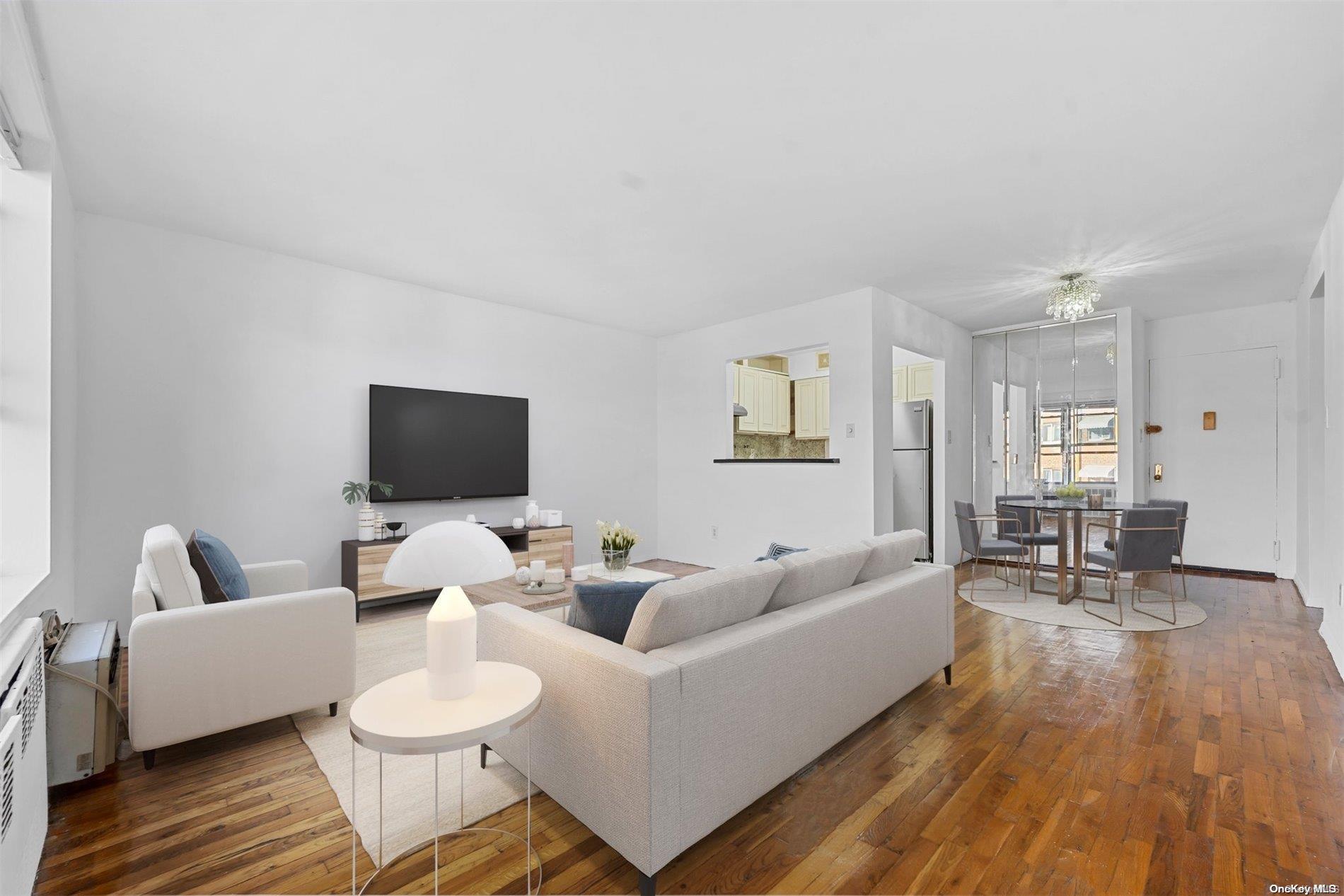 58-03 Calloway Street, Unit B3 Queens, NY 11368 - Photo 2 of 8 a living room with furniture and a flat screen tv