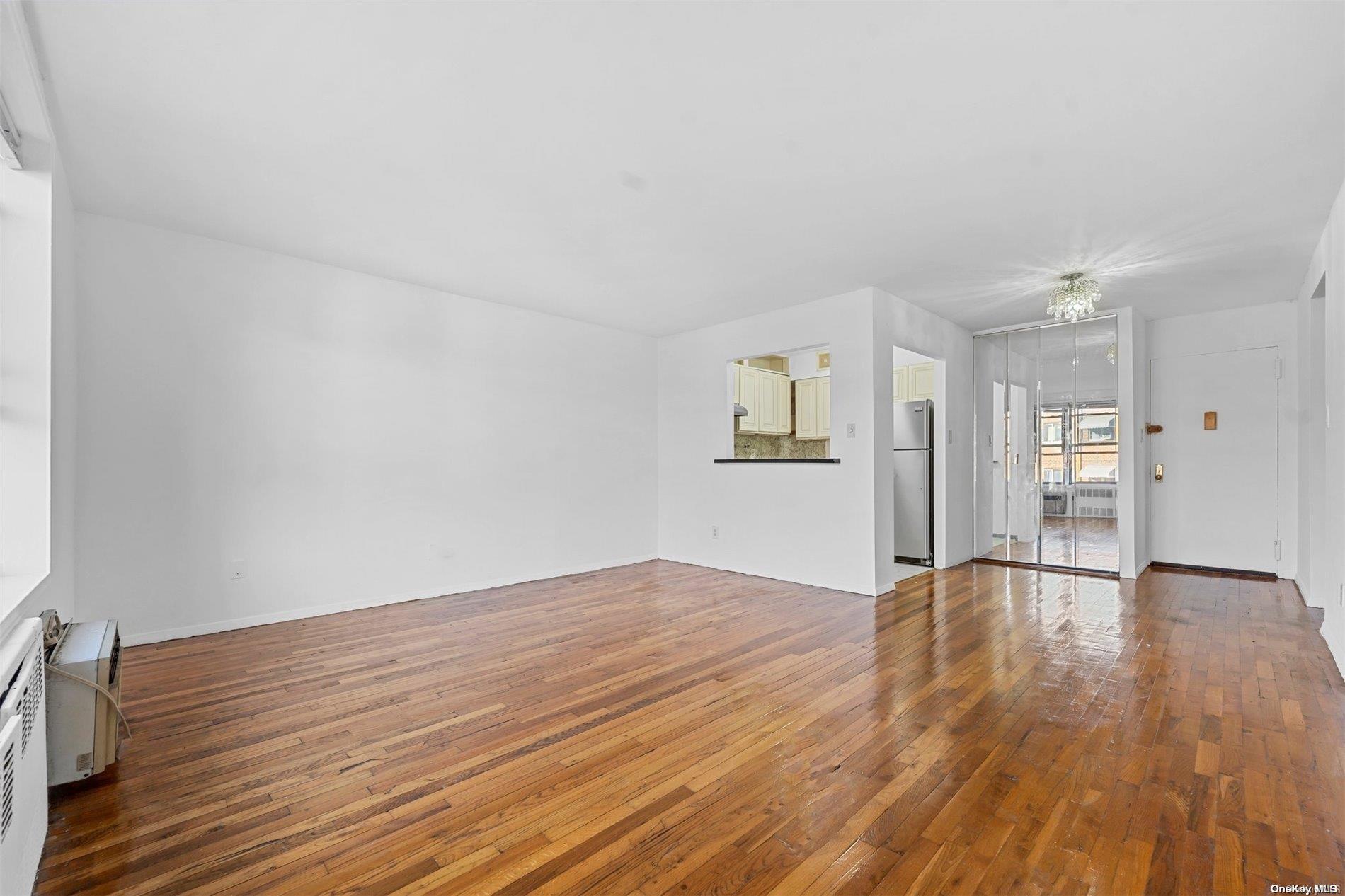 58-03 Calloway Street, Unit B3 Queens, NY 11368 - Photo 4 of 8 a view of empty room with wooden floor