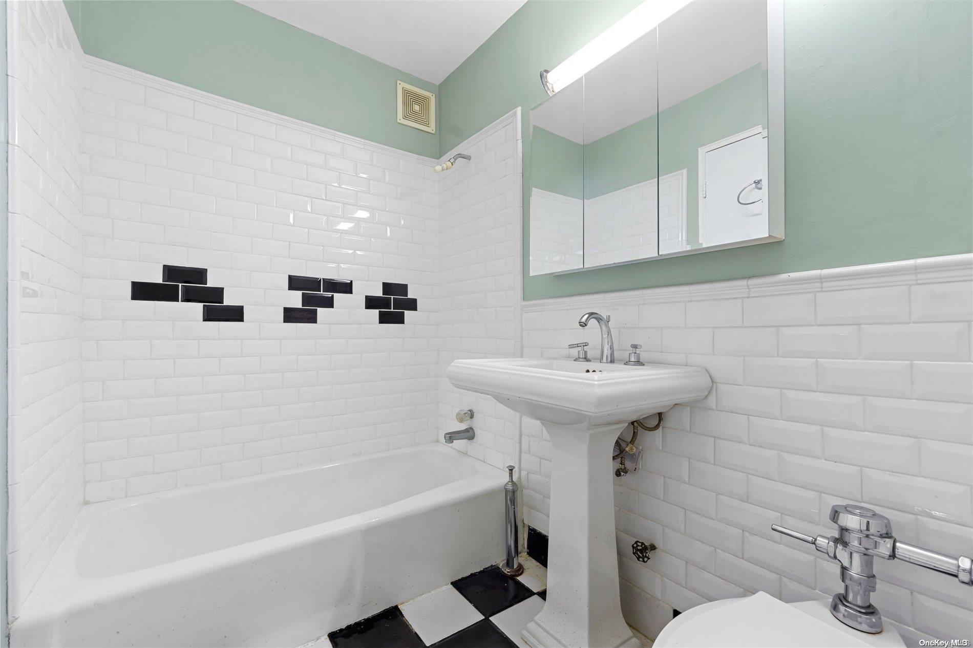 58-03 Calloway Street, Unit B3 Queens, NY 11368 - Photo 7 of 8 a bathroom with a sink a toilet and bathtub