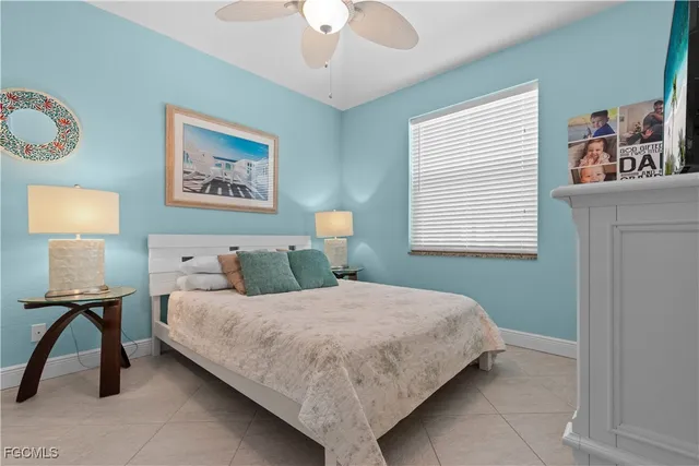 a bedroom with a bed and a lamp on table