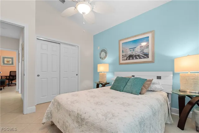 a bedroom with a bed and a painting on the wall