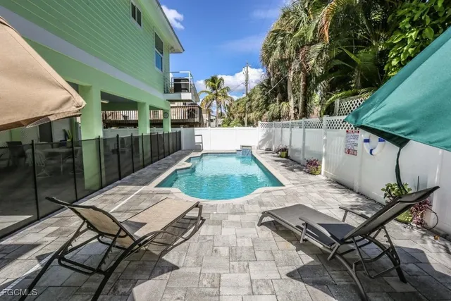 a view of a chairs and table in backyard