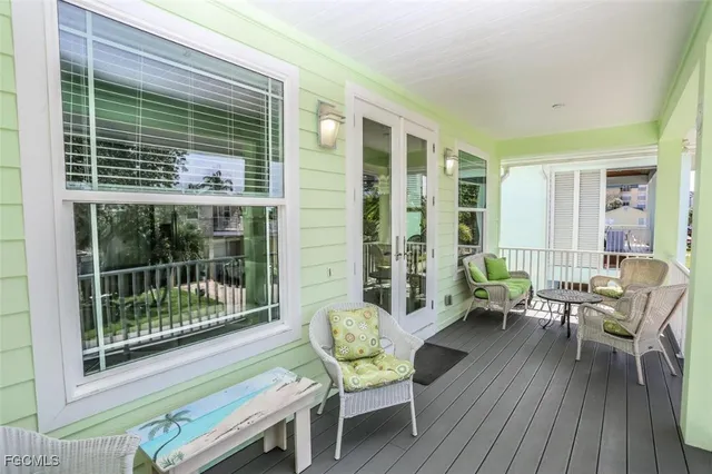 a balcony with furniture and wooden floor