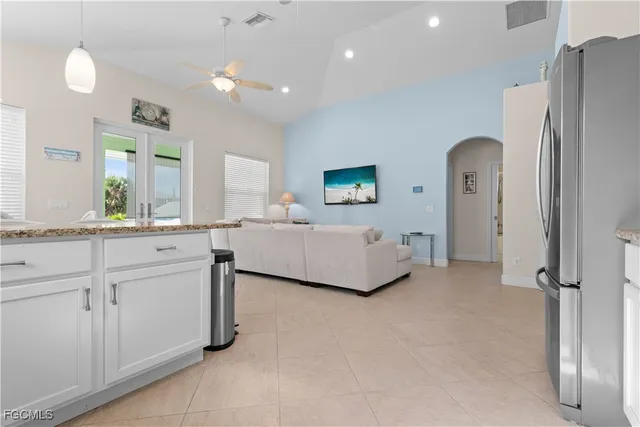 a spacious bedroom with a bed and a dresser