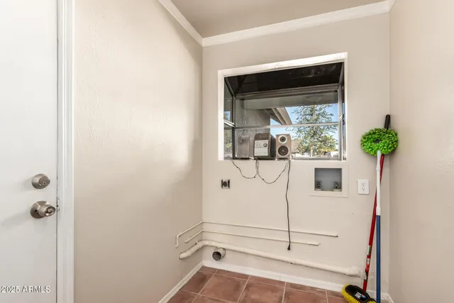 a view of a hallway with a potted plant on the wall