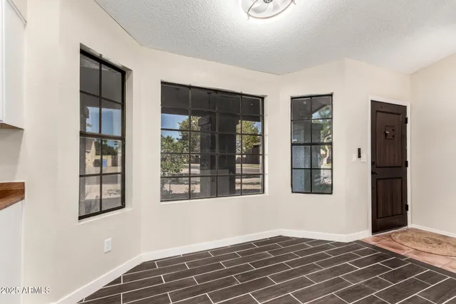 a view of an empty room with glass door