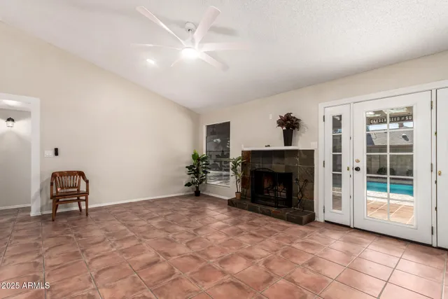 a view of an empty room with furniture and a fireplace