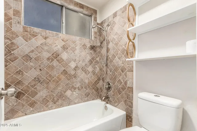 a bathroom with a bathtub and toilet