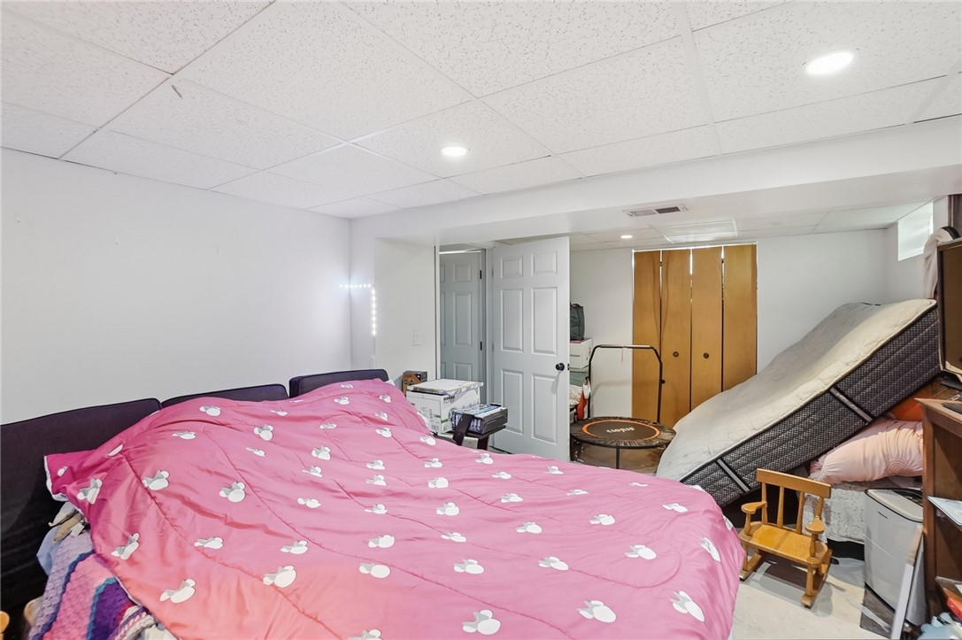 508 Storms Road Kettering, OH 45429 - Photo 24 of 32 This versatile basement space offers a bedroom area with practical closet storage and recessed lighting.