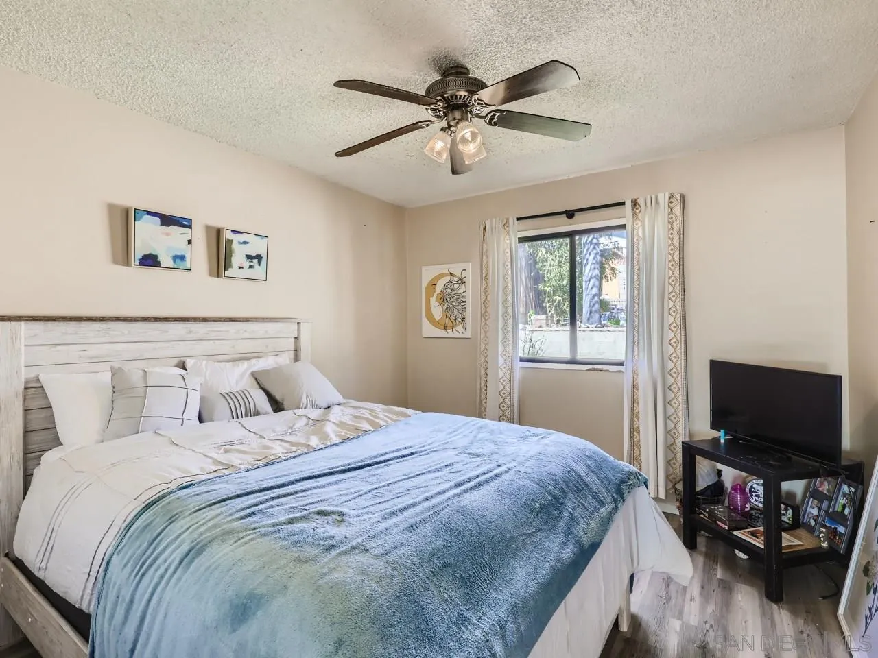 9456 Domer Road Santee, CA 92071 - Photo 13 of 30 a bedroom with a bed and a flat screen tv