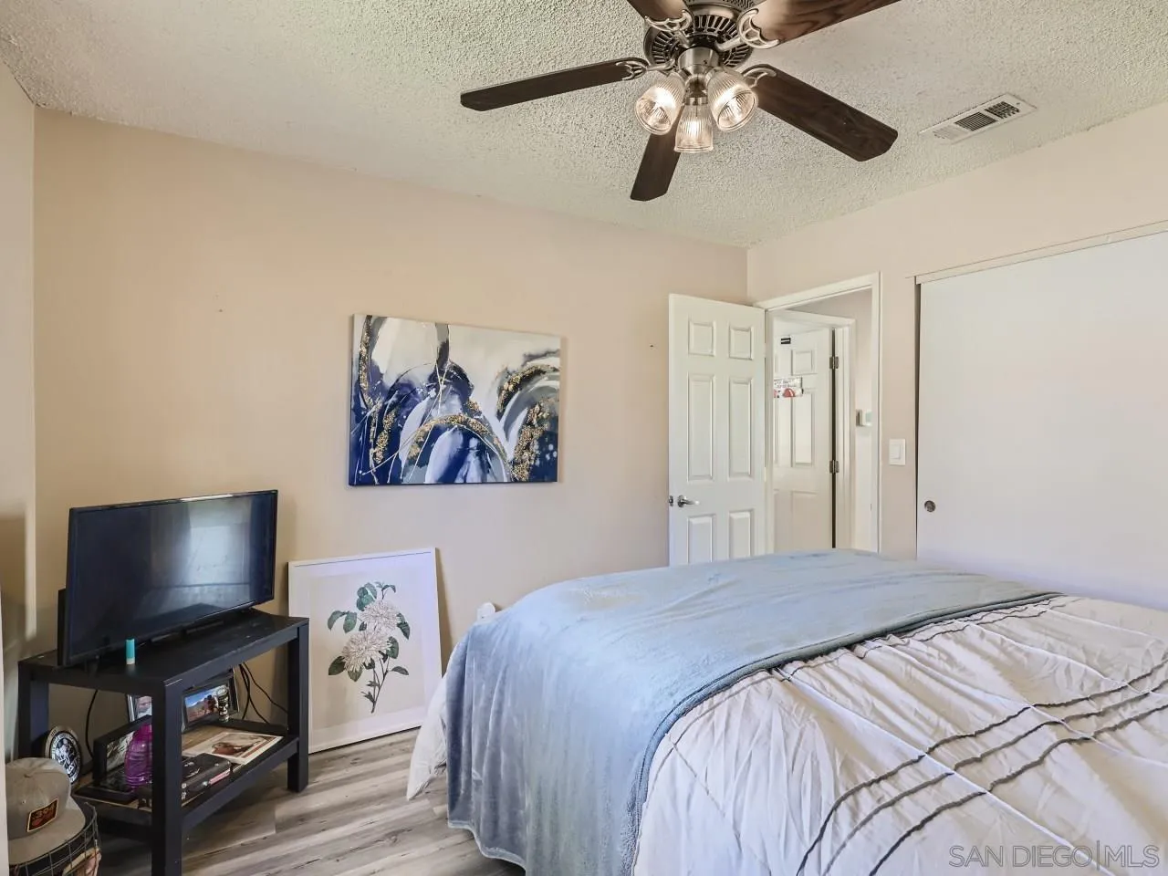 9456 Domer Road Santee, CA 92071 - Photo 14 of 30 a bedroom with a bed and a flat screen tv