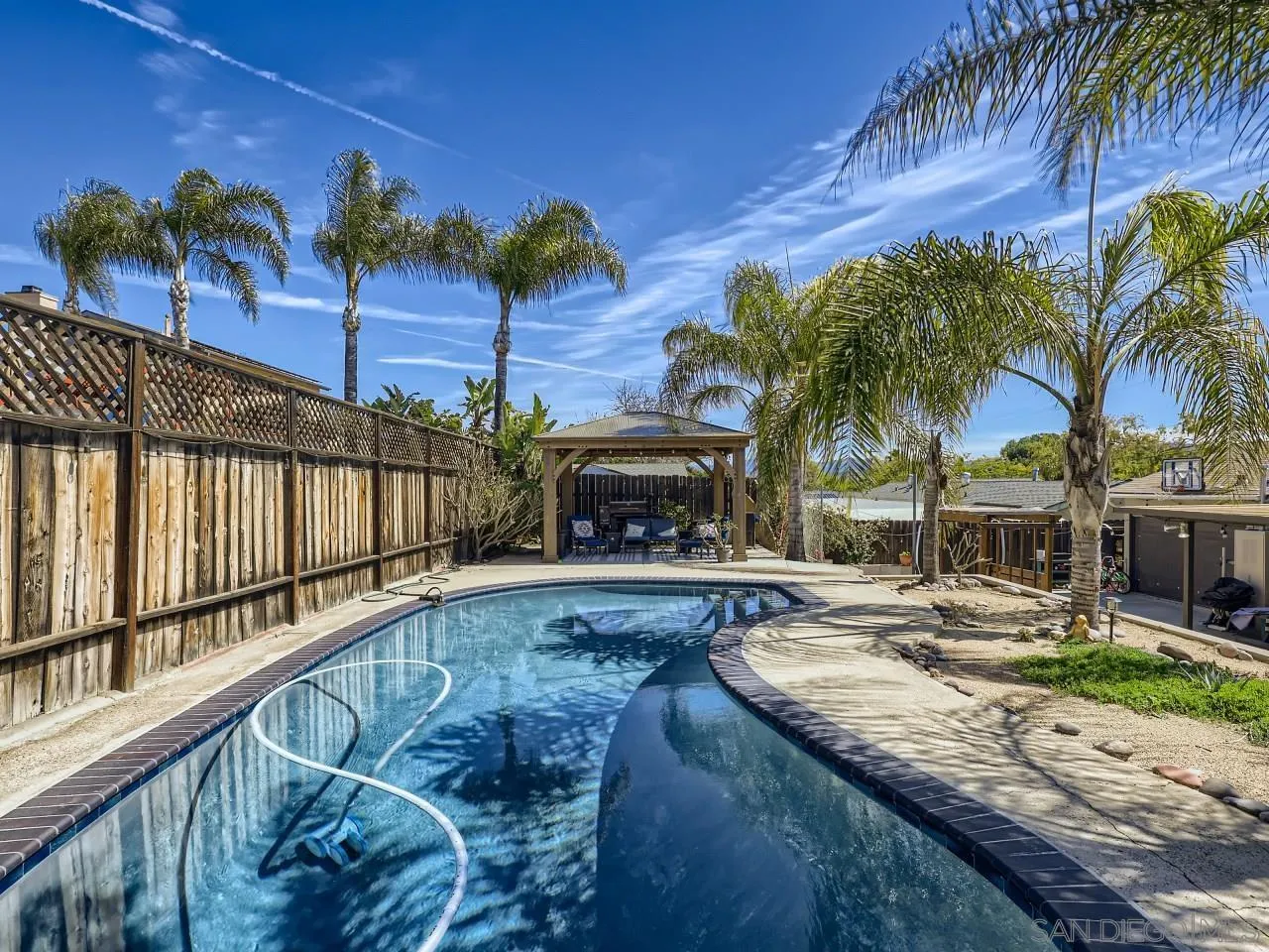 9456 Domer Road Santee, CA 92071 - Photo 2 of 30 a view of a backyard with a patio and palm tree