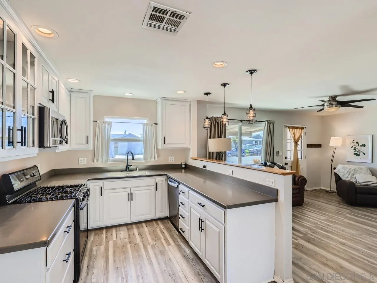9456 Domer Road Santee, CA 92071 - Photo 9 of 30 a kitchen with stainless steel appliances granite countertop a sink stove and refrigerator