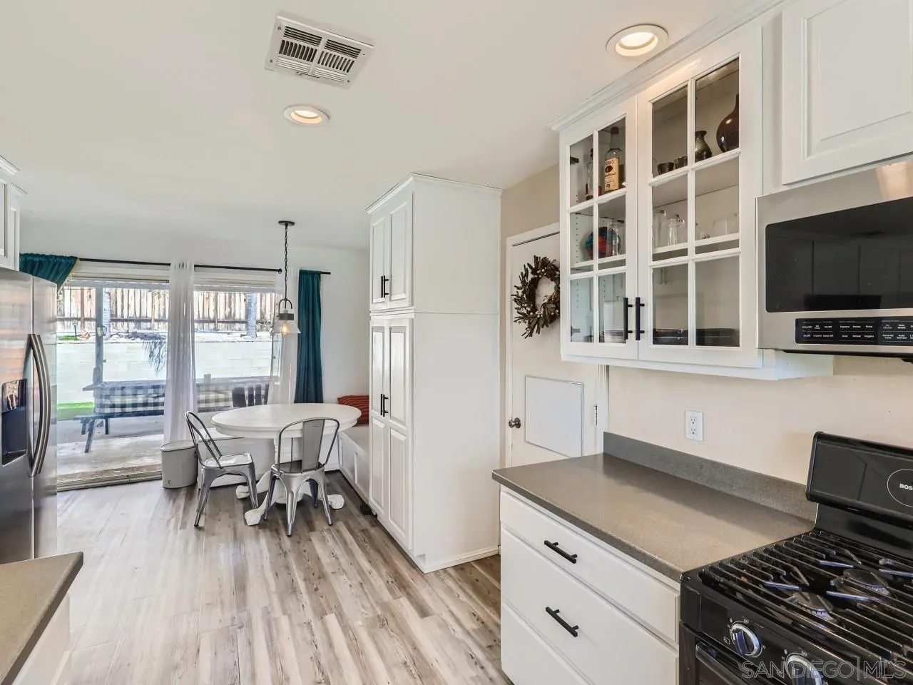 9456 Domer Road Santee, CA 92071 - Photo 10 of 30 a kitchen with stainless steel appliances a stove a sink and a refrigerator