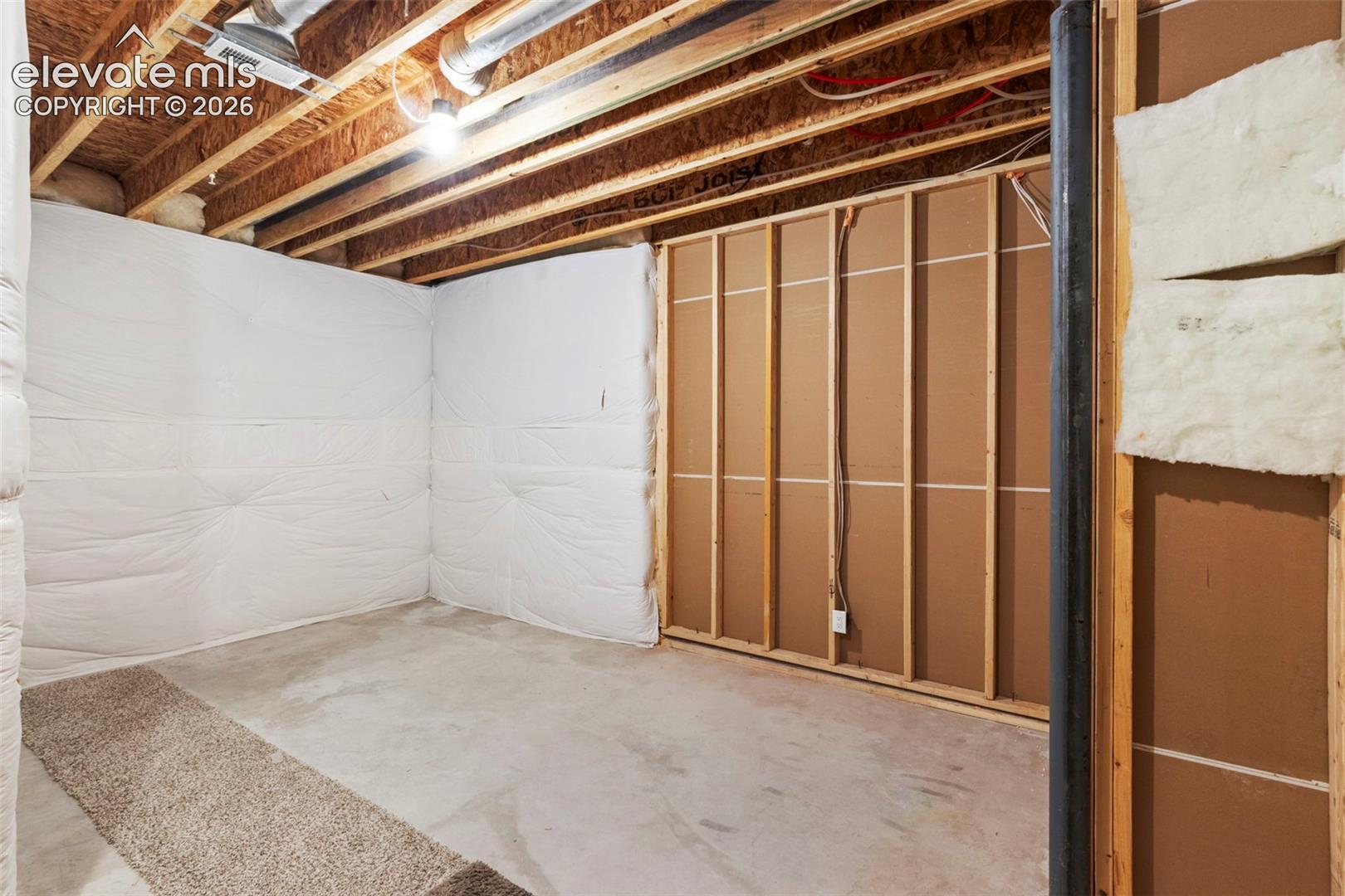 5375 Old Star Ranch View Colorado Springs, CO 80906 - Photo 39 of 47 Unfinished basement space featuring exposed wooden ceiling joists, concrete flooring, and partial wall insulation
