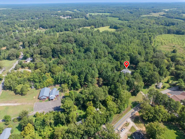 an aerial view of a house with a yard