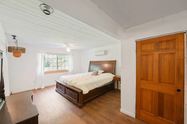 a white toilet sitting next to a white sink and vanity