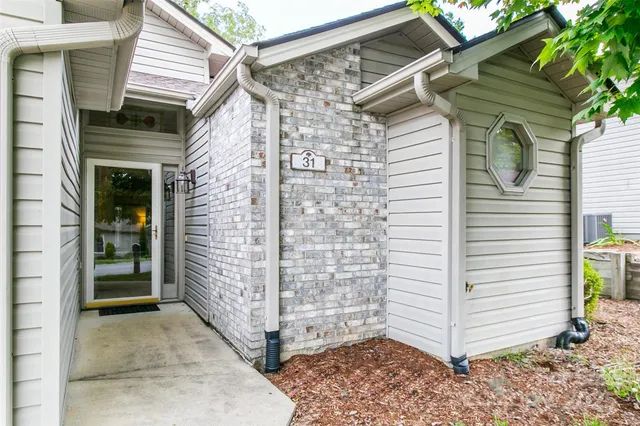 a view of front door and potted plants