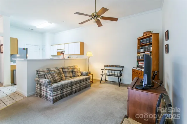 a view of a livingroom with workspace and a window