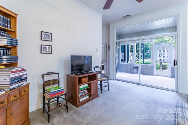 a kitchen with stainless steel appliances a stove a refrigerator a sink a stove and white cabinets with wooden floor