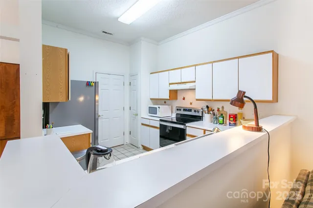 a kitchen with stainless steel appliances a stove a sink and a refrigerator