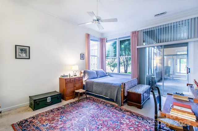 a bedroom with a bed a table and chair