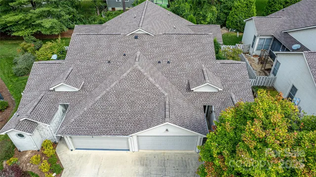 an aerial view of a house with a yard and garden