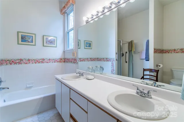 a bathroom with a tub sink and mirror