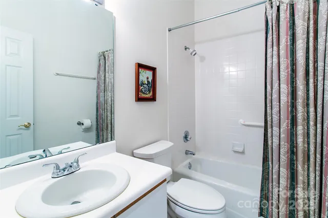 a bedroom with a bed a dresser and potted plants