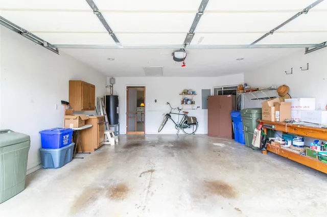 an aerial view of residential house with outdoor space and trees all around