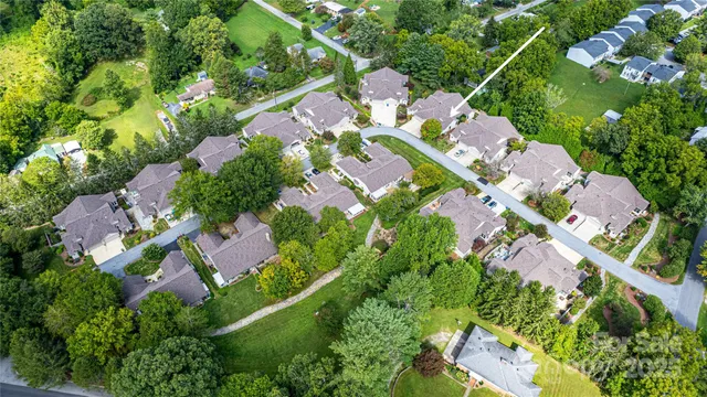 an aerial view of multiple houses with yard