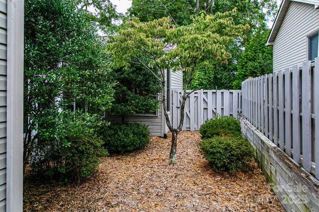 a view of a garden with wooden fence