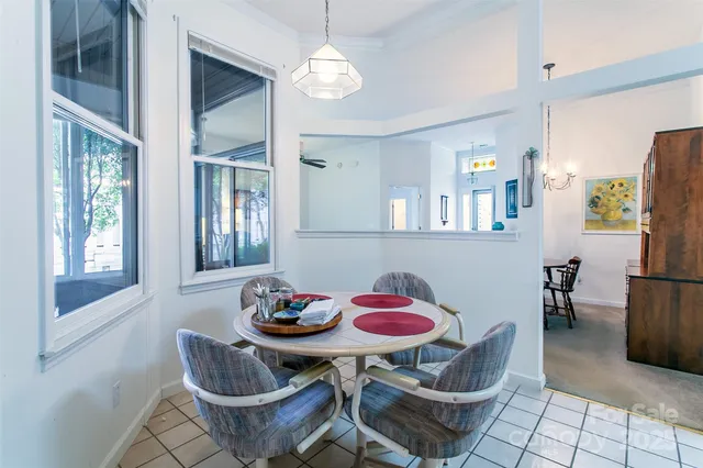 a view of a dining room with furniture and a chandelier