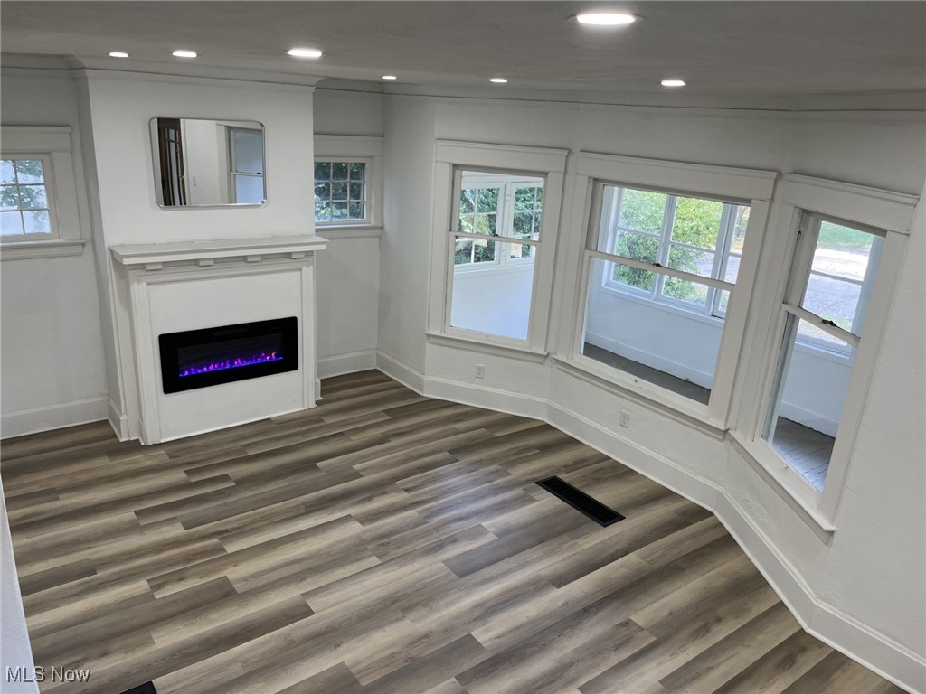 3264 Altamont Road Cleveland, OH 44118 - Photo 7 of 32 Unfurnished living room featuring recessed lighting, wood-looking flooring, and a glass covered fireplace
