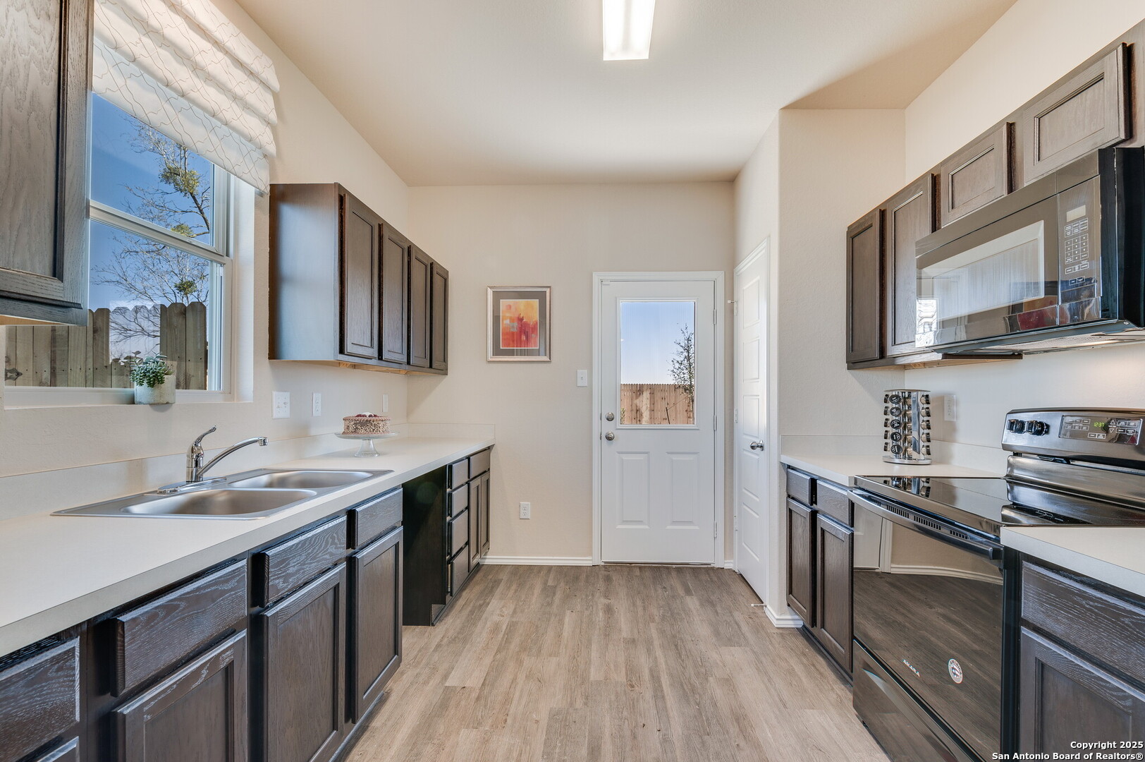 4947 Blue Ranch San Antonio, TX 78222 - Photo 9 of 27 a kitchen with a sink stove top oven and cabinets