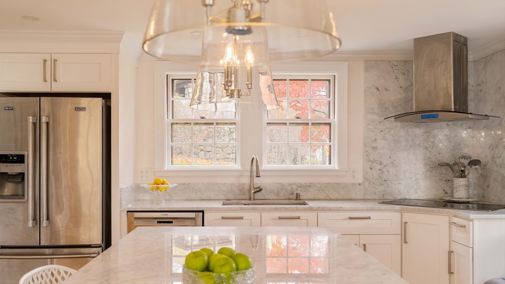 30 Prospect Street Winchester, MA 01890 - Photo 16 of 42 a kitchen with granite countertop a sink a window and stainless steel appliances