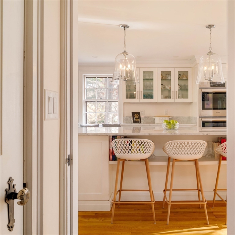 30 Prospect Street Winchester, MA 01890 - Photo 18 of 42 a table and chairs sitting in a kitchen next to a window