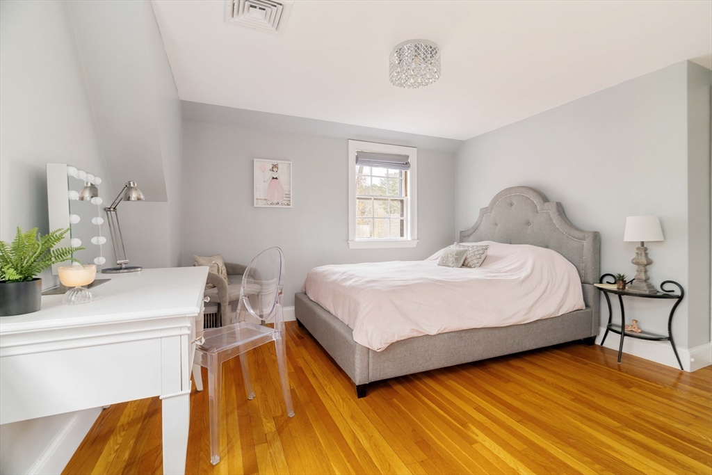 30 Prospect Street Winchester, MA 01890 - Photo 33 of 42 a bedroom with a bed and a table