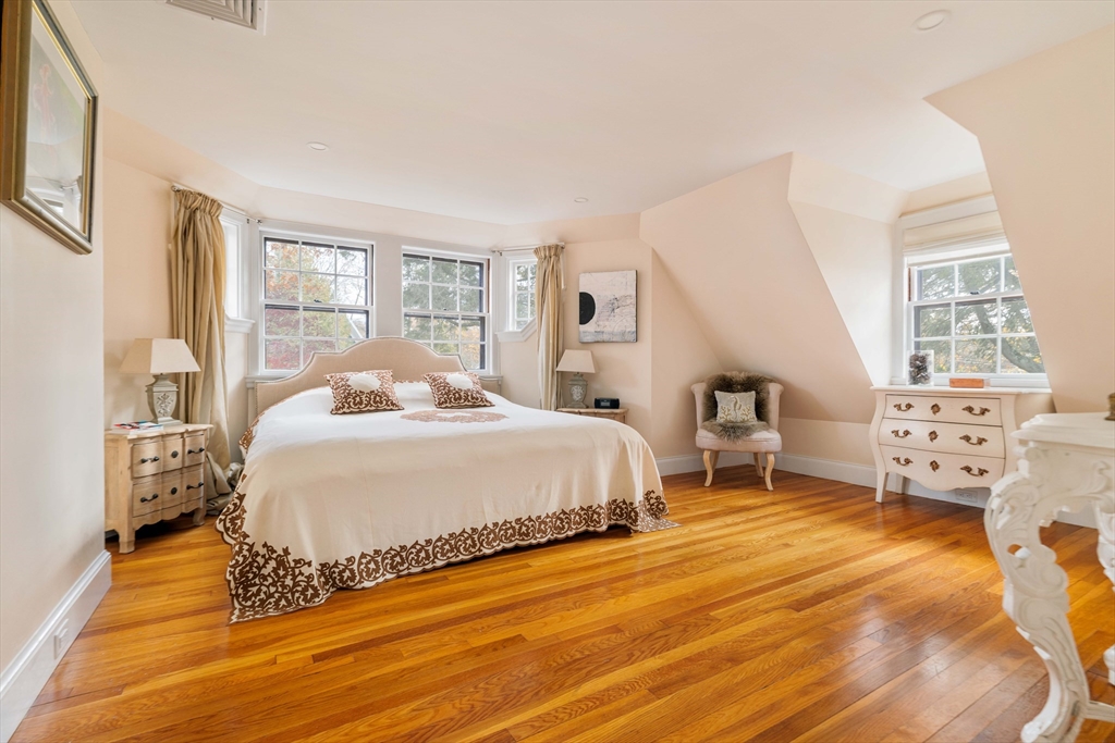30 Prospect Street Winchester, MA 01890 - Photo 36 of 42 a bedroom with a bed and wooden floor