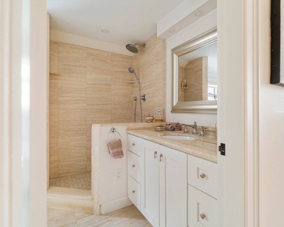 30 Prospect Street Winchester, MA 01890 - Photo 38 of 42 a bathroom with a granite countertop sink a mirror and a shower