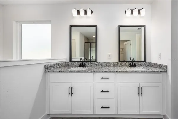a bathroom with sink mirror and vanity