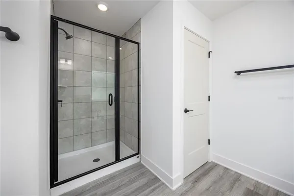 a bathroom with a glass shower door